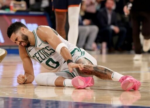 Jayson Tatum grimaces in pain after rupturing his Achilles tendon during Boston's defeat to the New York Knicks