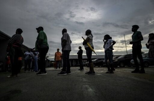 People queue before voting at a polling station during parliamentary elections in Paramaribo on May 25, 2025